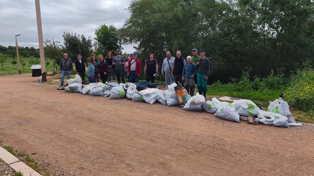 Voluntarios con las bolsas de residuos que han retirado del arroyo Pedroches.