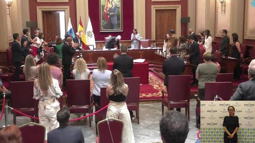 Evelyn Alonso (al fondo a la izquierda) saluda con el codo a José Manuel Bermúdez tras recoger el bastón de mando