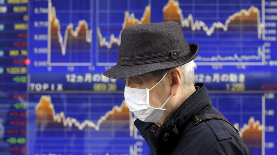 Un ciudadano pasa delante de una pantalla que muestra información bursátil en Tokio (Japón). EFE/Franck Robichon