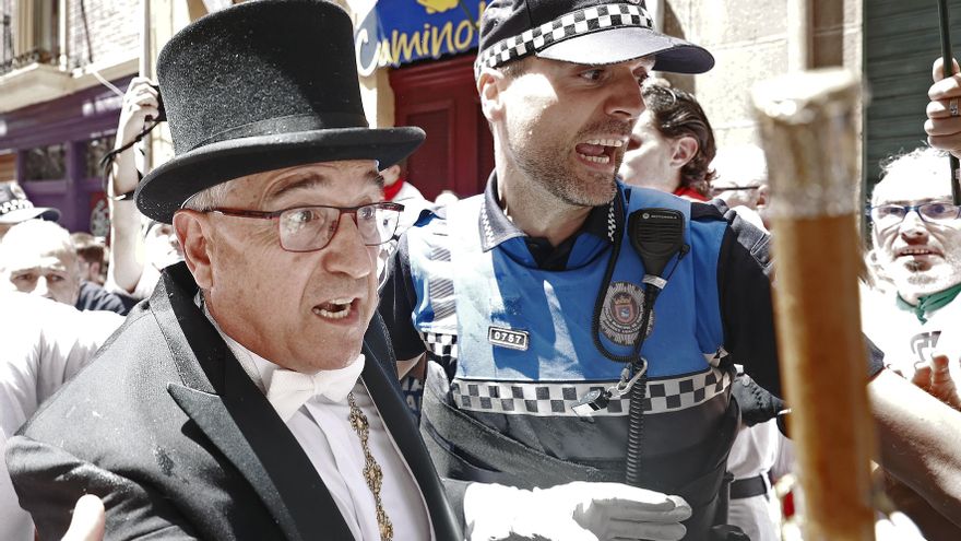 El alcalde de Pamplona Enrique Maya y un agente municipal en la calle Curia durante los altercados. EFE/ Jesús Diges