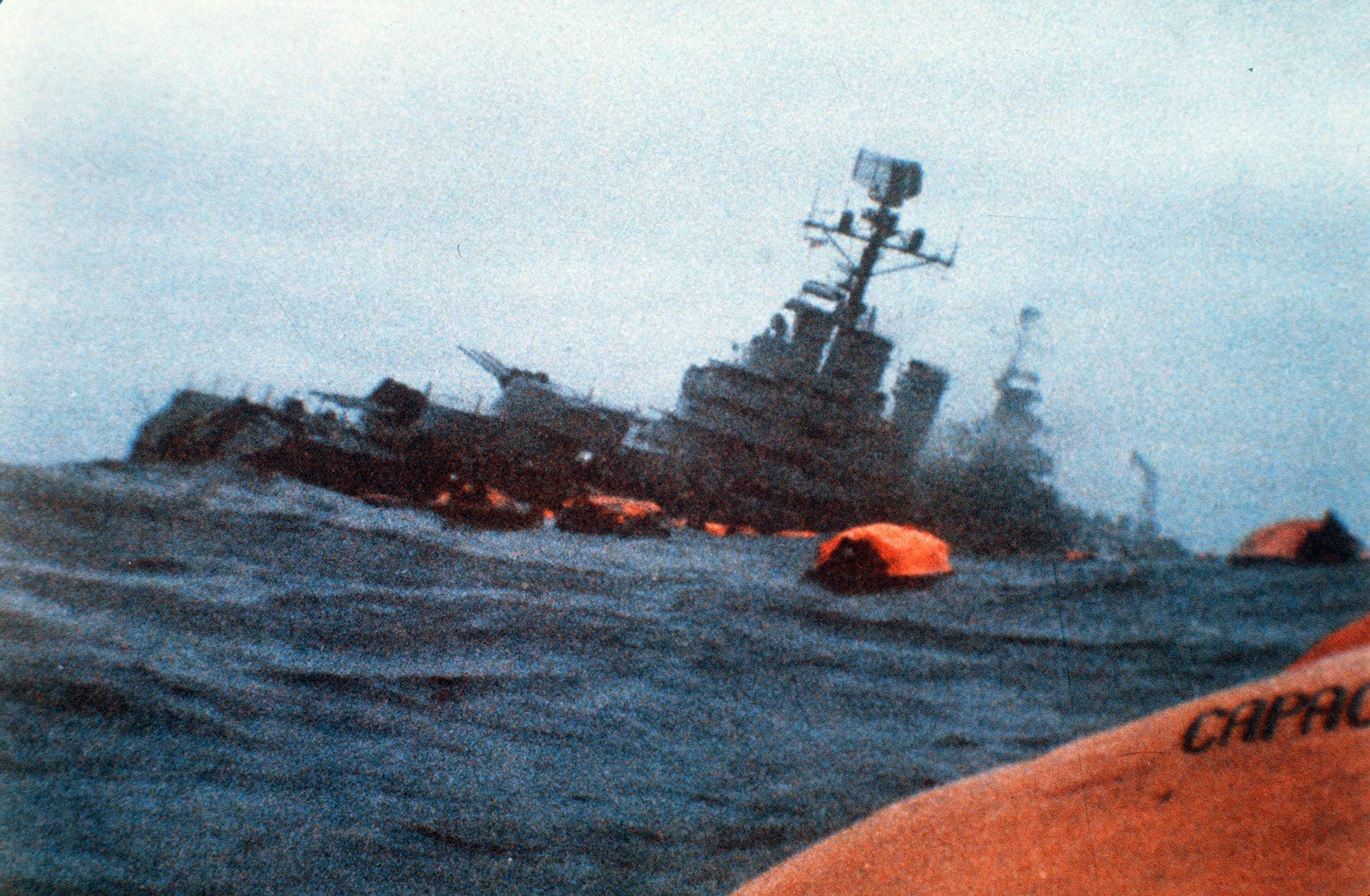 The Argentinian cruiser General Belgrano sinks amid orange life rafts holding survivors in the South Atlantic Ocean, after being torpedoed by the British Royal Navy in this May 1, 1982 file photo. On June 14, 1982, Argentine forces withdrew from the Falkland Islands after being defeated by British troops following a two-month war. (AP Photo)