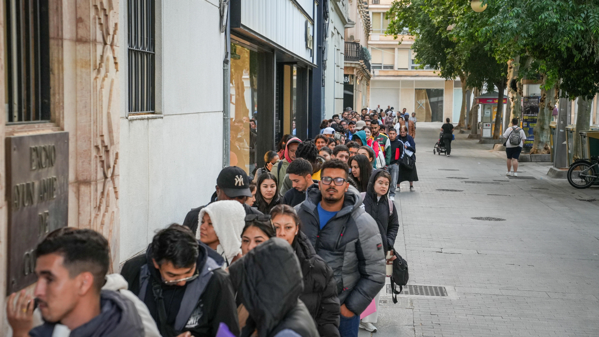 Largas colas de personas migrantes durante la atención presencial para su regularización