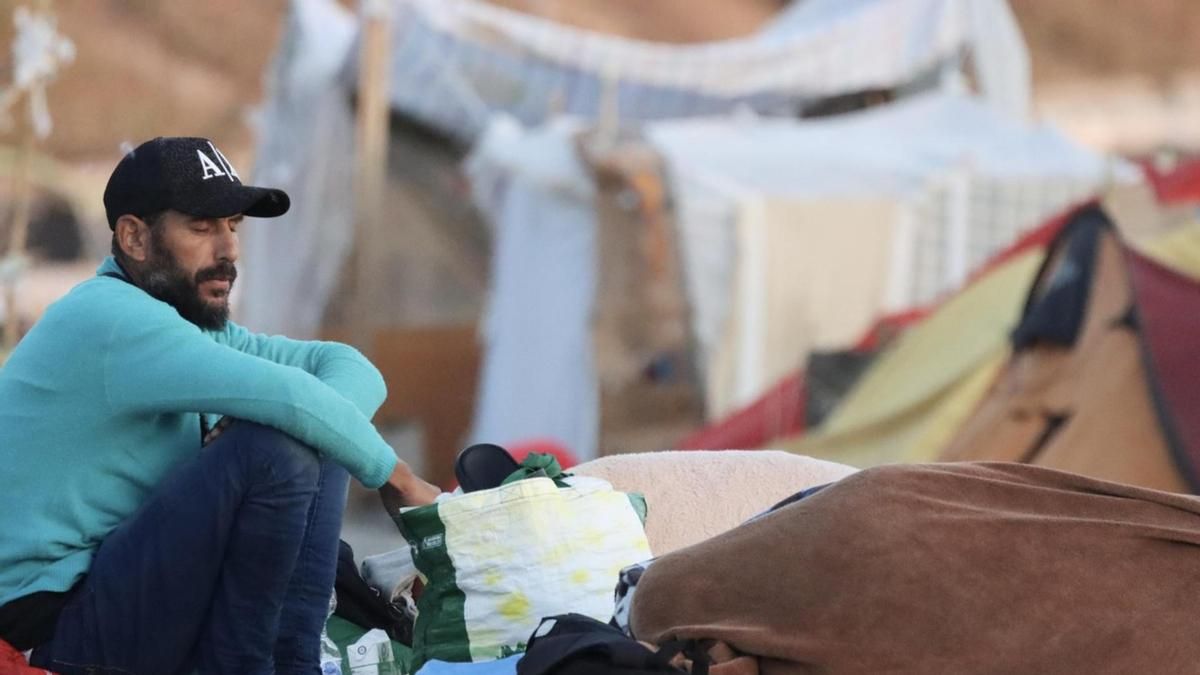 Migrantes en la playa de El Trampolín de Ceuta a primera hora de la mañana de este sábado.