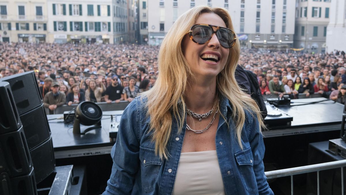 La alcaldesa Silvia Salis saluda al público antes de la actuación de Charlotte De Witte en el escenario durante un concierto en la Piazza Matteotti el 11 de abril de 2026 en Génova.
