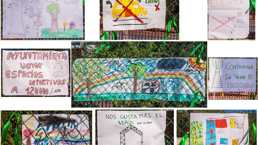 Dibujos pintados por los niños y niñas del CEIP Juan Zaragüeta y colgados en la valla que separa el colegio del parking.