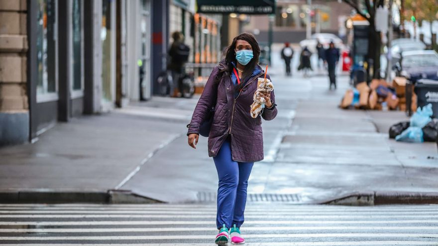 Una mujer pasea con mascarilla por Nueva York, Estados Unidos