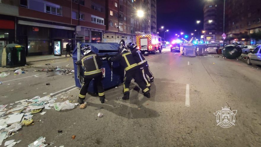 Los bomberos despejan las calles tras los disturbios.