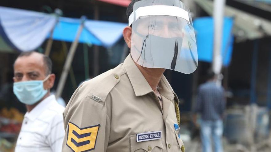 Imagen de archivo de un miembro de la policía india con mascarilla y diversas protecciones para evitar el contagio