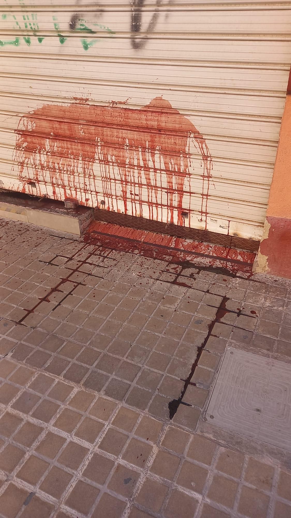 Manchas rojas en otra de las persianas de la sede de CEAR en València.