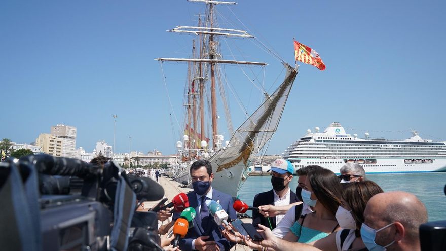 Juanma Moreno atiende a los medios de comunicación tras la recepción al Buque-Escuela Juan Sebastián Elcano en Cádiz.