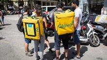 Imagen de varios repartidores con mochilas de Glovo y Deliveroo en Barcelona.