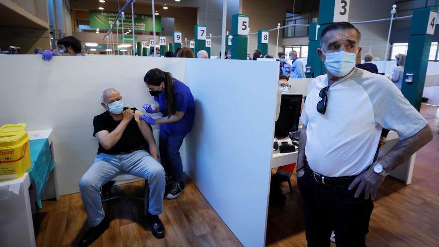 Una sanitaria vacuna a un hombre en el estadio de la Cartuja de Sevilla, un centro de vacunación masiva frente al Covid.EFE/Jose Manuel Vidal/Archivo