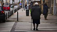 Una anciana cruza un paseo de cebra en la ciudad. | ALMA CAMACHO