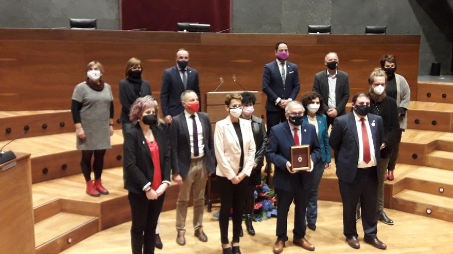 Luis Sabalza, presidente de Osasuna, con la Medalla de Oro del Parlamento de Navarra, entre la presidenta del Gobierno de Navarra, María Chivite, y el presidente del Parlamento foral, Unai Hualde.