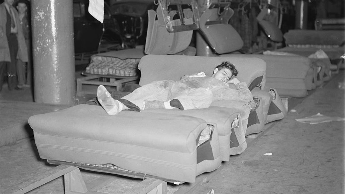 Huelguista durmiendo en la línea de montaje de asientos de automóviles en la fábrica de Flint, en 1937.