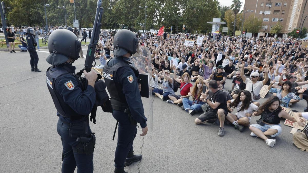 Agentes antidisturbios, frente a las personas que han organizado una sentada al final de la manifestación en València por la vivienda.