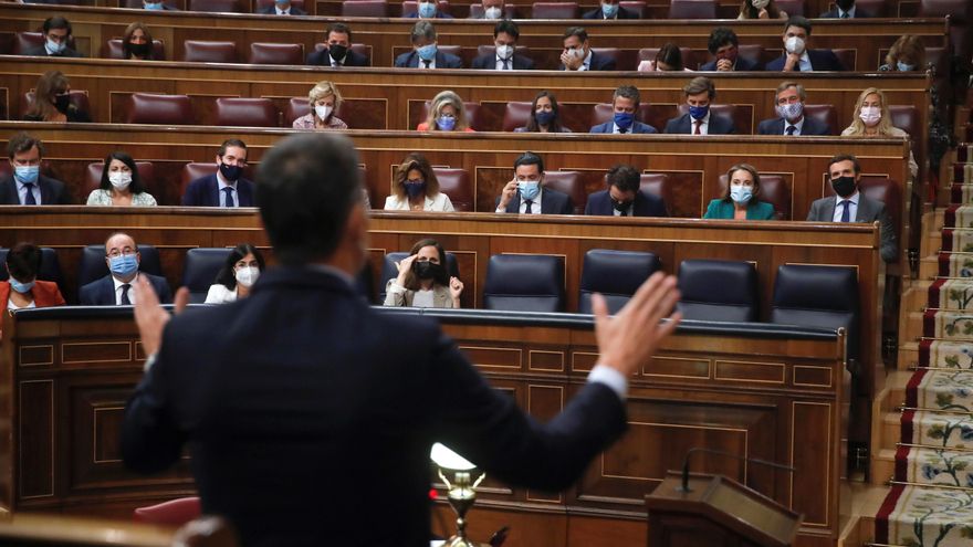El presidente del Gobierno, Pedro Sánchez (de espaldas), responde al líder del PP, Pablo Casado (d), en una sesión de control al Gobierno. EFE/Juan Carlos Hidalgo