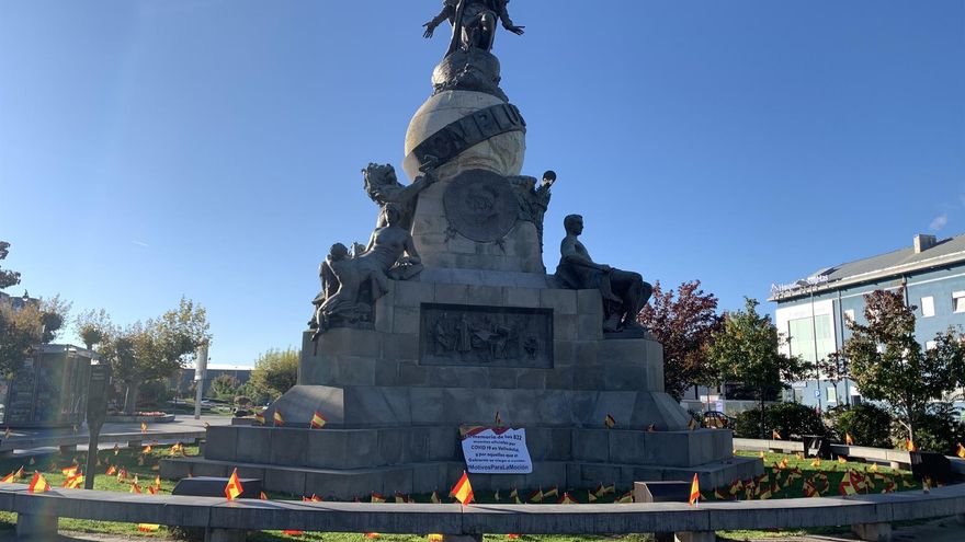 El monumento a Cristóbal Colón en Valladolid rodeado por banderitas de España. - EUROPA PRESS