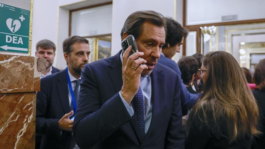 El ministro de Transportes, Óscar Puente, atiende al teléfono en los pasillos del Congreso durante el pleno celebrado este jueves.