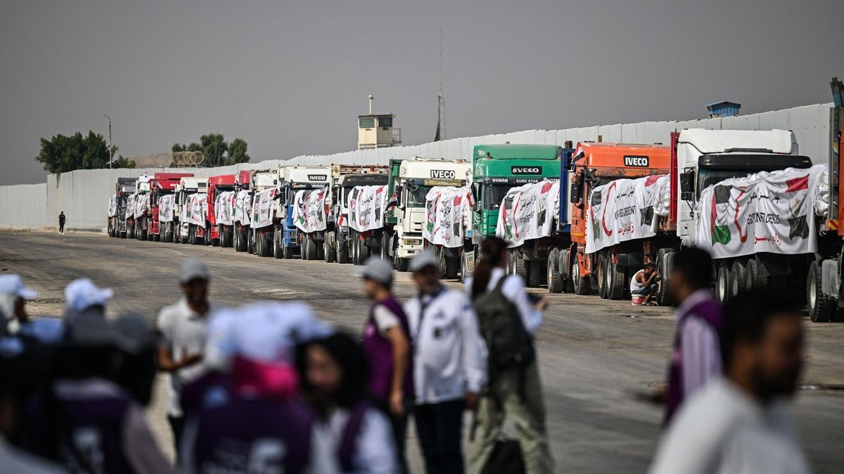 Trucks loaded with humanitarian aid wait on the Egyptian side of the border with Gaza.