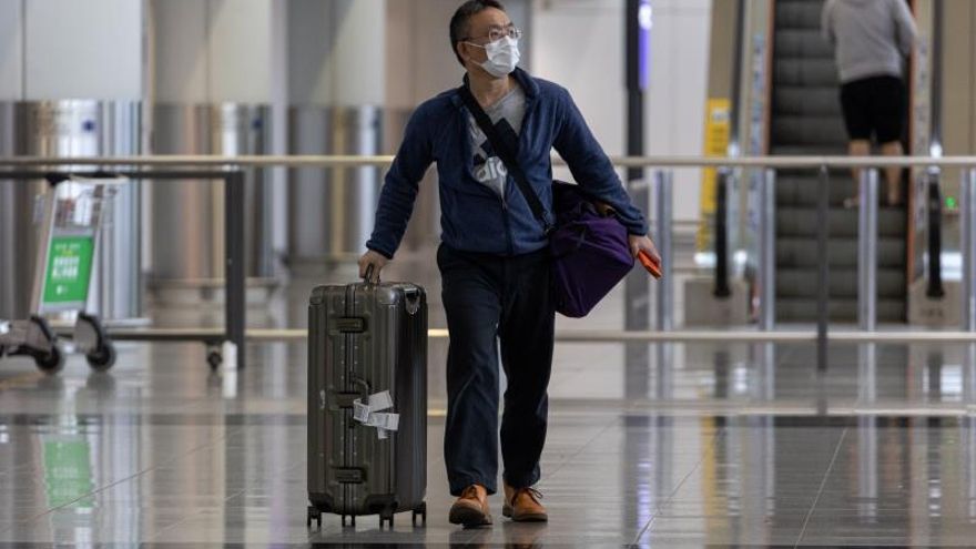 A traveller wears a mask in the arrival hall of the Hong Kong International Airport in Hong Kong, China, 22 January 2020.