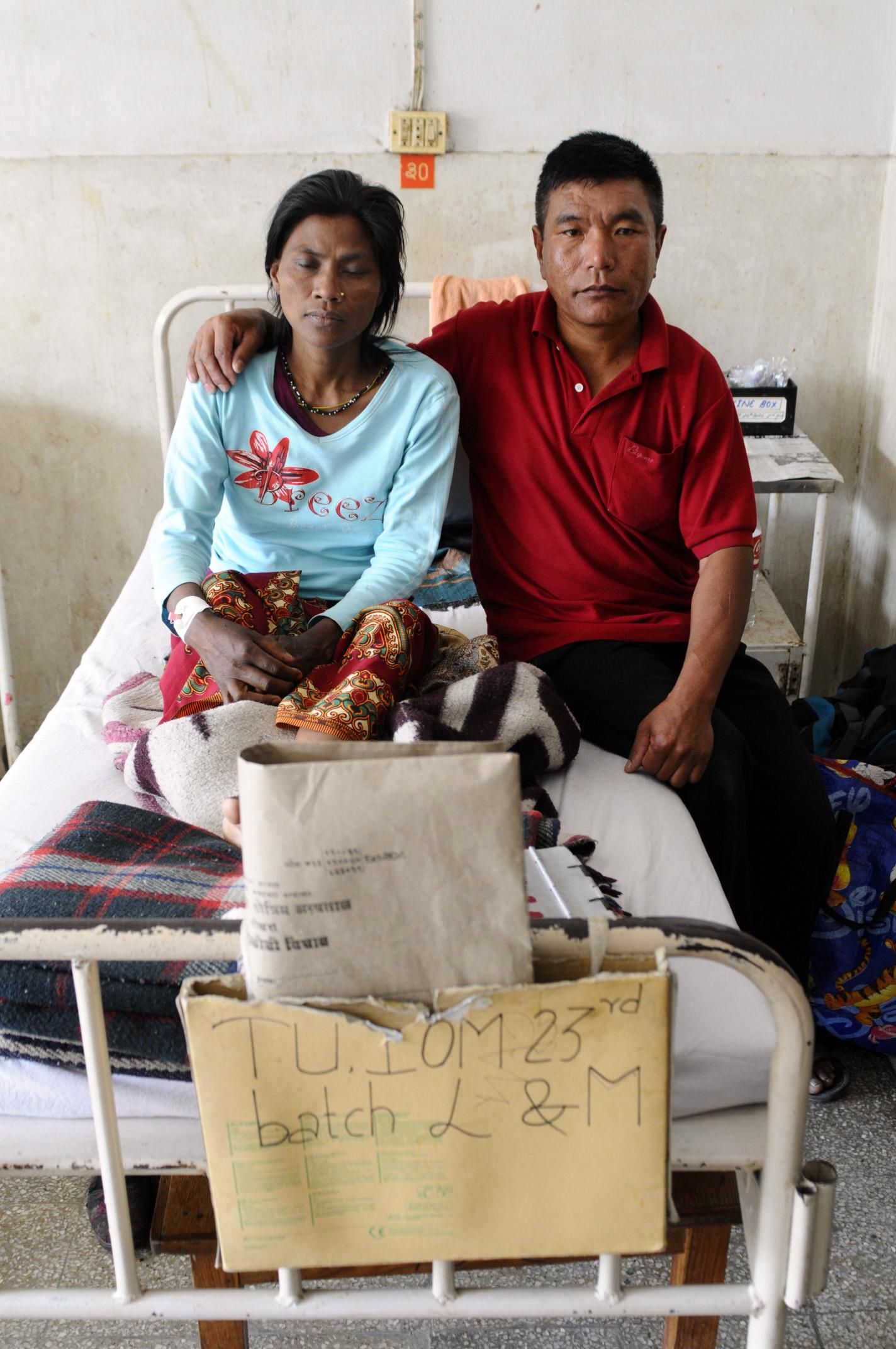 Pobitra Tapa Maghar, ex alcohólica, no prestó atención a las manchas que se extendían por su cuerpo hasta que fue demasiado tarde. Ahora los médicos luchan por salvarle la vida en un hospital de Pokhara. A diferencia de lo que sucede en muchos otros casos, su marido sigue a su lado, y posa con ella en la cama del hospital./ Zigor Aldama