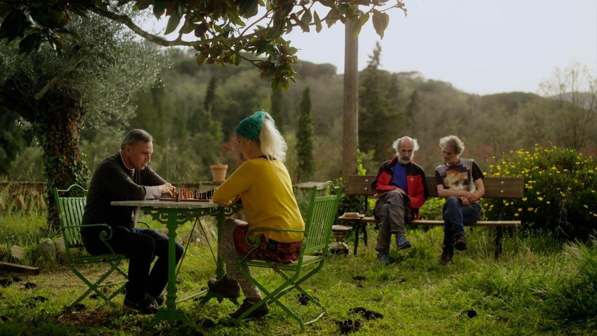 Quatre dels set germans Pomar Pérez, en una imatge del documental de Joan Gamero: n’Eduard i na Consol s’enfronten als escacs mentre, al fons del pla, n’Adolf i en José Luis xerren asseguts al banc
