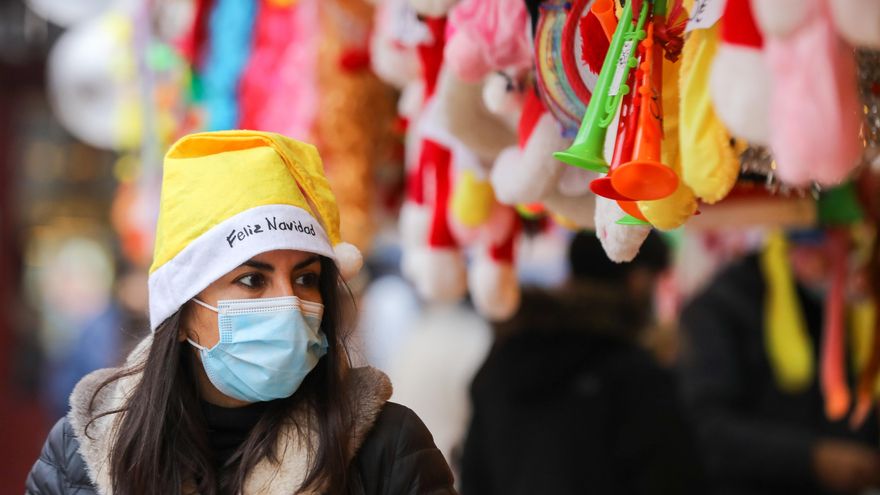 Una mujer con un gorro de Papa Noel y una mascarilla, el mismo día que entra en vigor la obligatoriedad de usar mascarilla en exteriores.