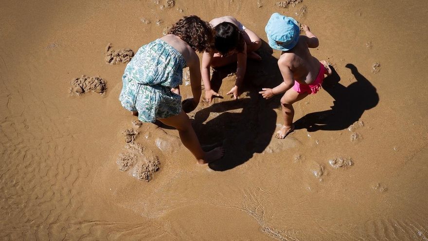 Varios niños juegan en la playa de La Concha de San Sebastián.