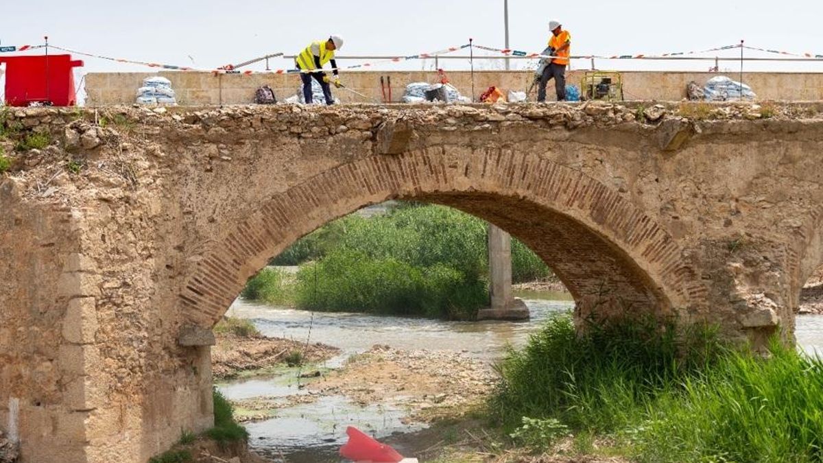 Operarios trabajan en el puente histórico del Túria.