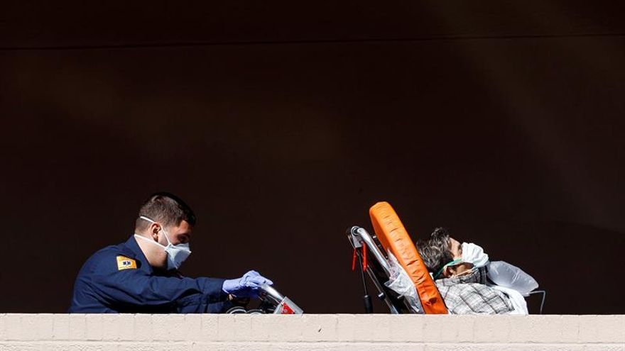 Paramedics bring a patient into the emergency room entrance of the Wyckoff Heights Medical Center in Brooklyn, New York, USA, 01 April 2020.