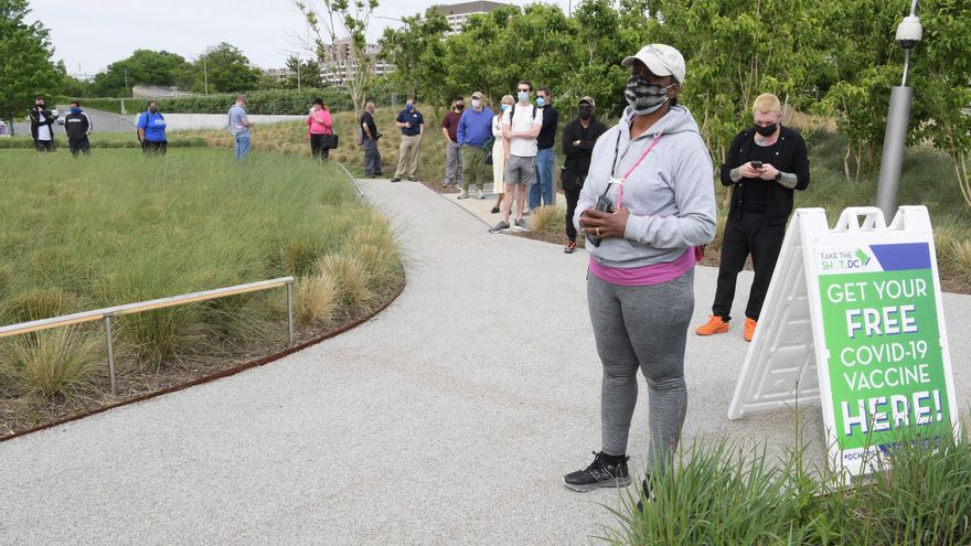 Decenas de personas esperan su turno para vacunarse contra la covid-19 este jueves durante una tarde de "cerveza a cambio de vacuna" organizada por la Alcaldía del Distrito de Columbia en el Kennedy Center de Washington. EFE/Lenin Nolly