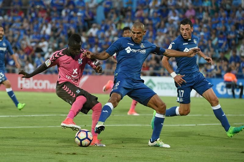 El defensa argentino del Getafe 'Cata' Díaz (c) pelea un balón con el centrocampista senegalés del Tenerife Diedhiou