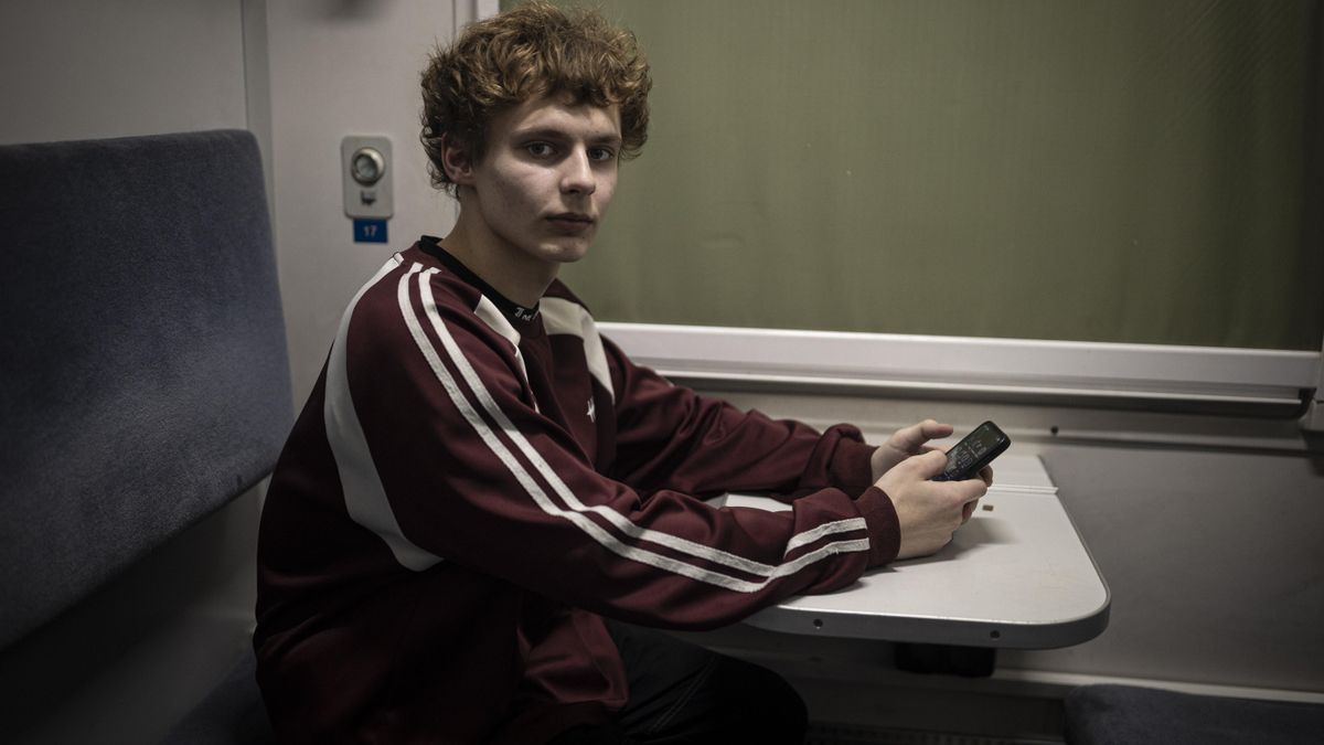 Stanislav, de 14 años, en un vagón de tren habilitado en Kiev como punto de emergencia para calentarse