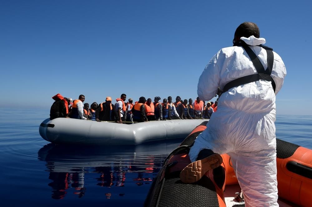 Tras haber repartido chalecos, la lancha semi-rígida se aproxima de nuevo al bote inflable donde viajaban 98 personas. El siguiente paso será trasladarlas en pequeños grupos, de entre 10 y 20 personas, hasta el MY Phoenix, el barco de MOAS que cuenta con personal médico de MSF. Fotografía: Ikram N'gadi