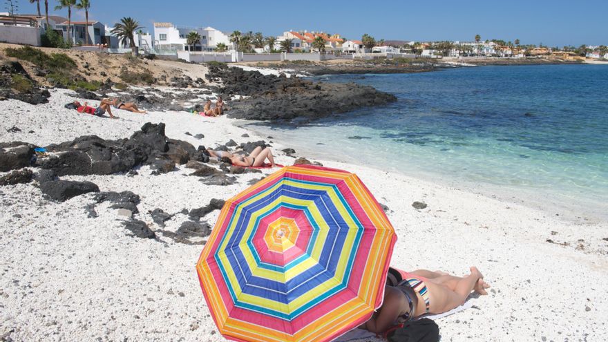 Turistas disfrutan de un día de playa en la localidad de Corralejo, en el norte de Fuerteventura, en Canarias. EFE/Carlos de Saá/Archivo