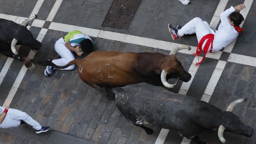 Toros de la ganadería gaditana de Cebada Gago a su paso por la calle de la Estafeta durante el quinto encierro de los Sanfermines, este lunes en Pamplona. EFE/Villar López