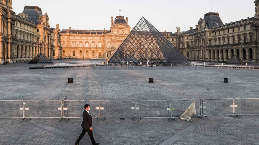 Un hombre pasea frente al museo del Louvre, en París.