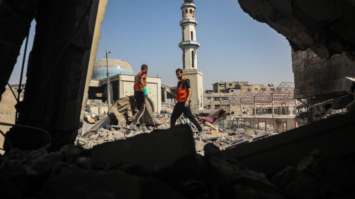 Trabajadores de la defensa civil de Ciudad de Gaza inspeccionan una casa destruida tras un bombardeo israelí el 16 de agosto.