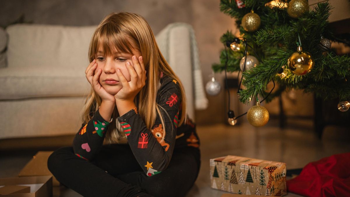 Una niña triste con sus regalos