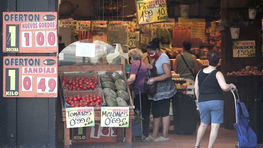 Archivo - Varias personas compran en una frutería