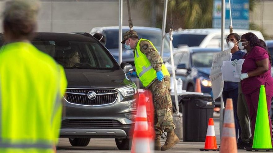 Florida Army National Guard's members conduct nasal swabs and coronavirus tests at the testing location at Hard Rock Cafe Miami's Super Bowl stadium's parking lot in Miami, Florida, USA, 23 March 2020.