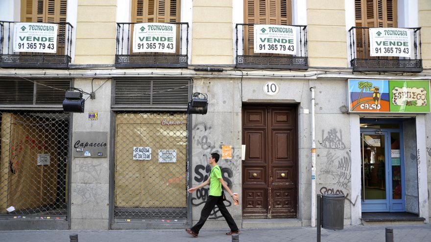 Vista parcial de la fachada de un edificio de viviendas ubicado en la calle del Duque de Alba con varios carteles de "Se vende".