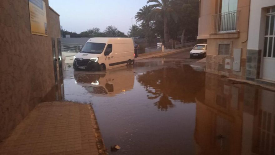 Una calle colindante al estanque queda inundada de agua tras su rotura