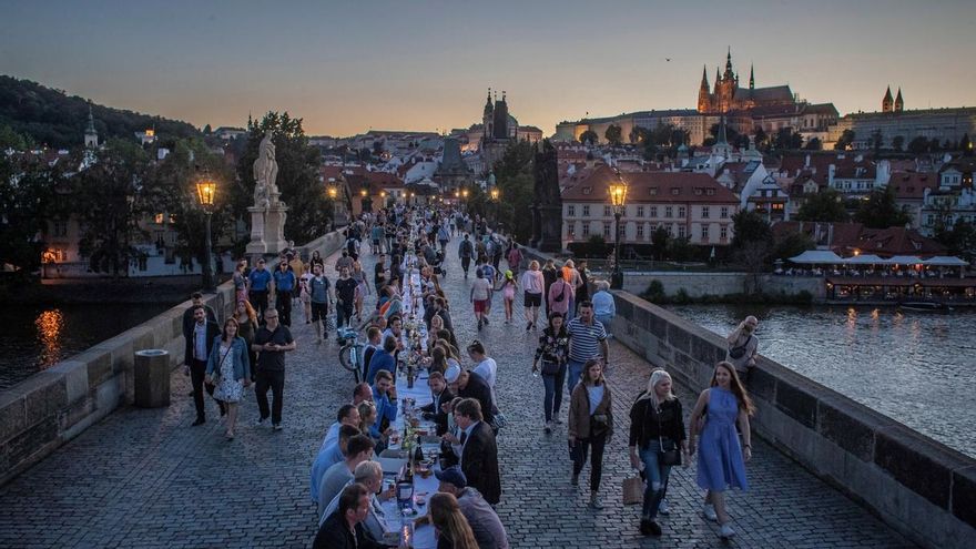 Vista de los comensales sentados en una mesa gigantesca de 515 metros de longitud y que abarca todo el icónico puente de Carlos en Praga, República Checa. La cena masiva se realizó tras la relajación de las restricciones impuestas en un intento de frenar la propagación de la pandemia COVID-19.