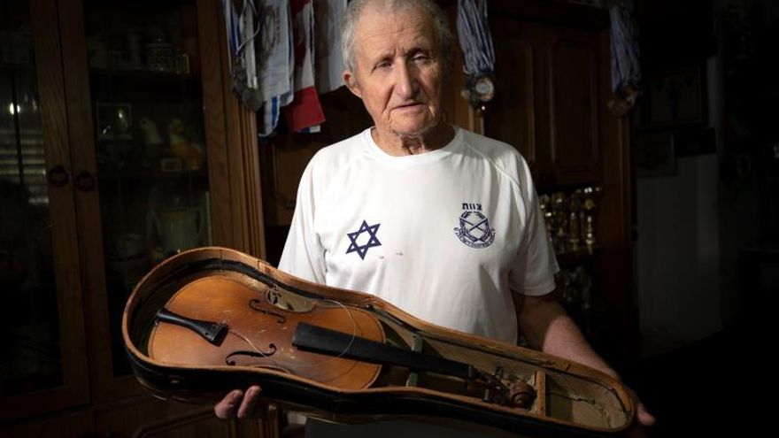 Hanoch Shacher, a Holocaust survivor born in Czech in 1935, survivor of the Theresienstadt concentration camp in what is now the Czech Republic and moved to Israel in 1949, holds his violin that he carried form Theresienstadt concentration camp, in northern city of Tzfat, Israel, 11 March 2019 (Issued 21 January 2020).