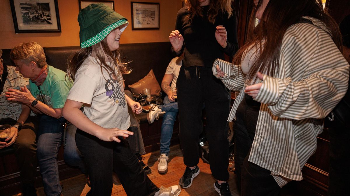 A group of people celebrating St. Patrick's Day in an Irish pub in Australia