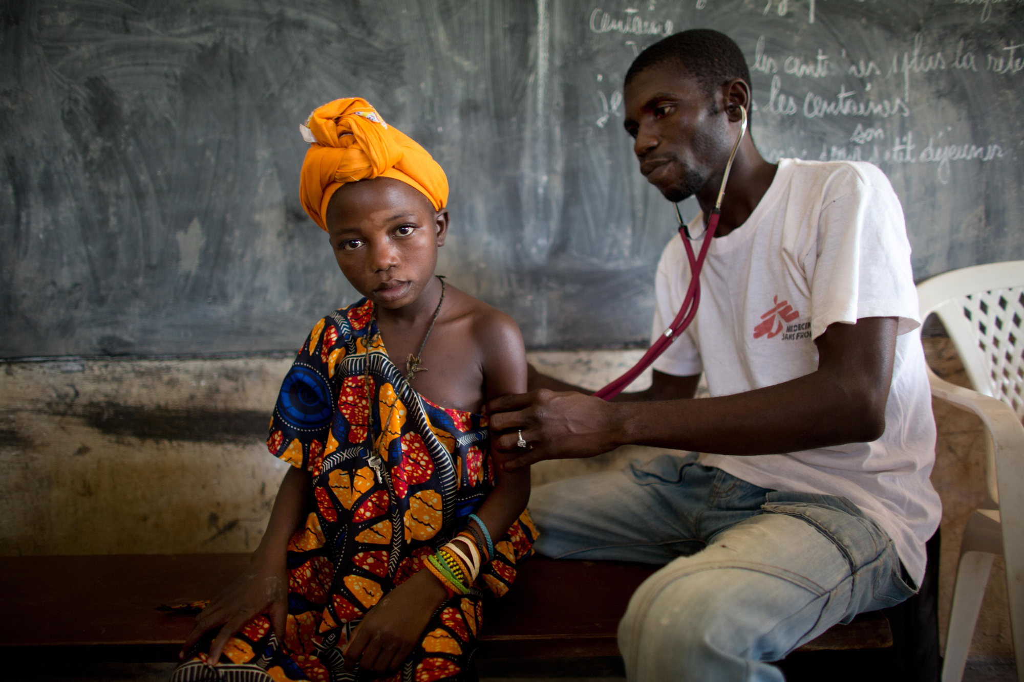 Eric Konate,  enfermera de Médicaos sin Fronteras trata a un niño enfermo que padece malaria en una clínica móvil situada en la aldea de Bolom, en la República Centroafricana. MSF ha puesto en marcha una respuesta de emergencia en el noroeste del país como apoyo a un hospital local y los centros de salud, después de que éstos fueron saqueados durante el golpe de estado. Muchas de las mujeres y los niños padecen malaria, la principal enfermedad sufrida por los niños en el país. / Fotografía: Tom Koene