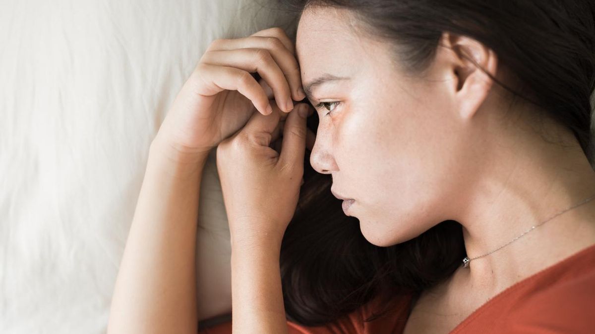 Adolescente triste en la cama