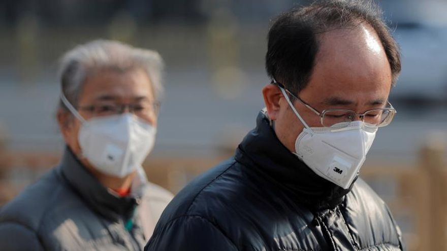 People wear masks in Beijing, China, 22 January 2020.